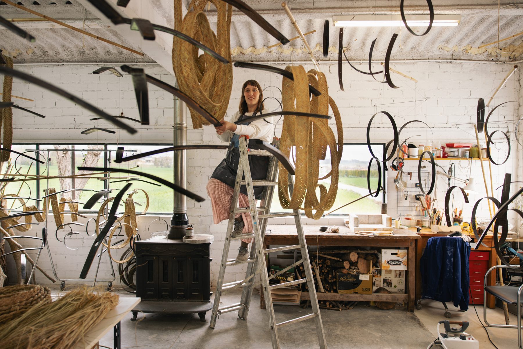 Aloma Lafontana in her studio among suspended pieces